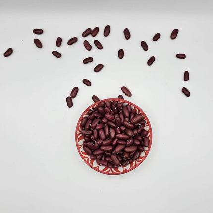 Red beans in a red bowl on a white background