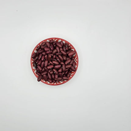 Red beans in a red bowl on a white background