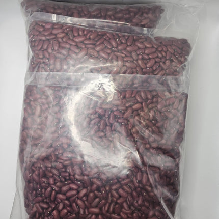 Clear plastic bag filled with red beans on a white background